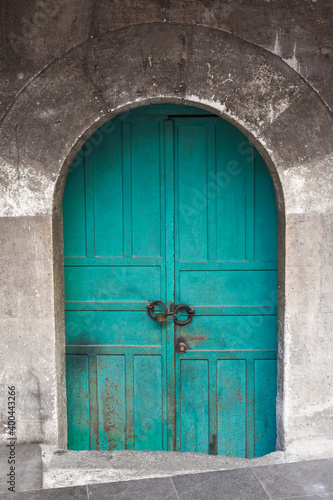 Old vintage mosque door on stone wall. Blue wooden door in Istanbul, Turkey. © Ersin