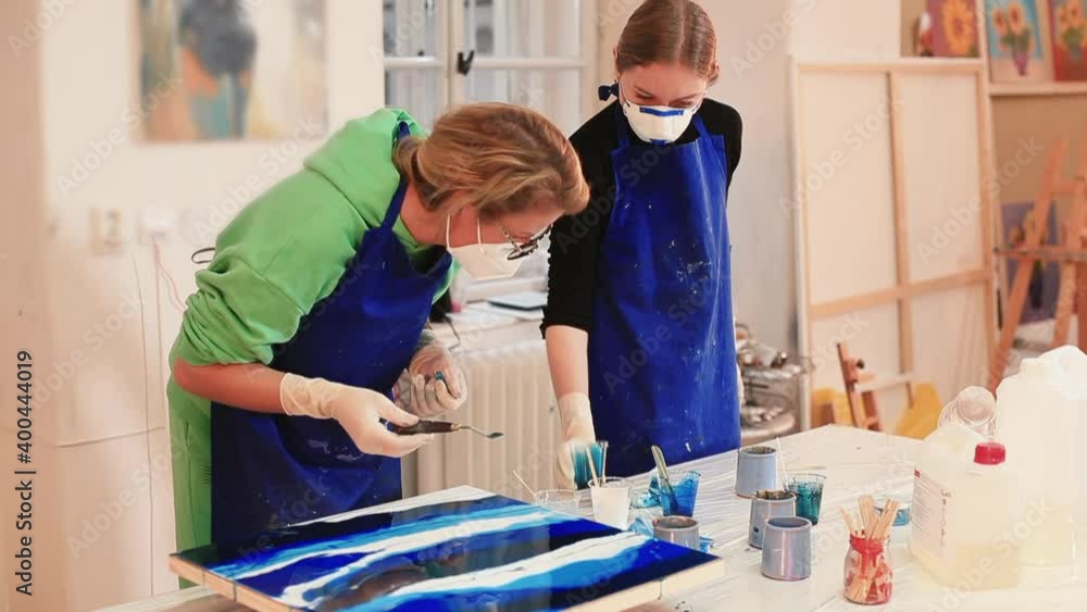 Video Stock Two artists create a work of art. An inspired artist pours