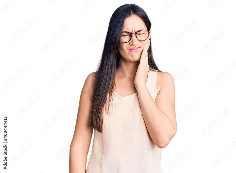 Young beautiful caucasian woman wearing casual clothes and glasses touching mouth with hand with painful expression because of toothache or dental illness on teeth. dentist Young beautiful caucasian woman wearing casual clothes and glasses touching mouth with hand with painful expression because of toothache or dental illness on teeth. dentist