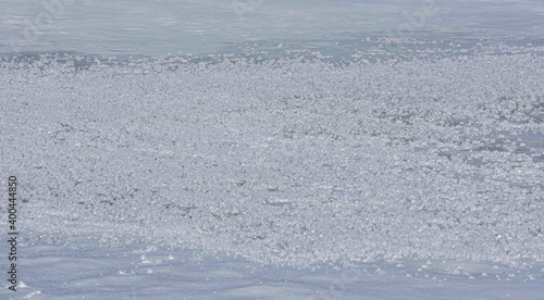 Snow crystals on the ice of a frozen river