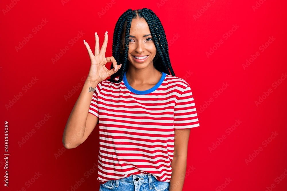 Beautiful hispanic woman wearing casual clothes smiling positive doing ok sign with hand and fingers. successful expression. Beautiful hispanic woman wearing casual clothes smiling positive doing ok sign with hand and fingers. successful expression.
