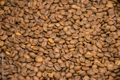 Dark many roasted coffee beans texture background. Top view