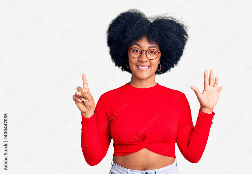 Young african american girl wearing casual clothes and glasses showing and pointing up with fingers number six while smiling confident and happy. Young african american girl wearing casual clothes and glasses showing and pointing up with fingers number six while smiling confident and happy.
