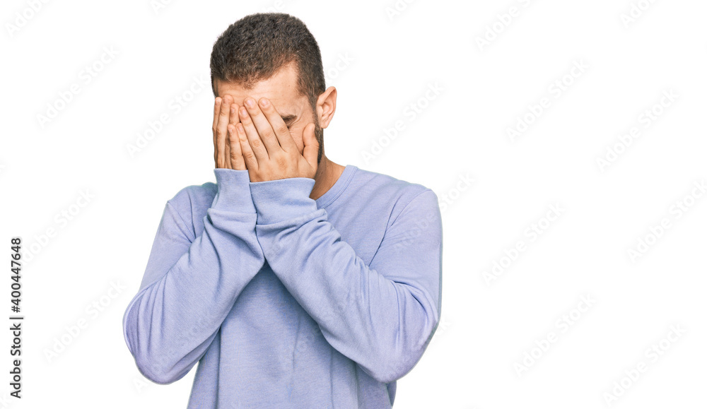 Young caucasian man wearing casual clothes with sad expression covering face with hands while crying. depression concept. Young caucasian man wearing casual clothes with sad expression covering face with hands while crying. depression concept.