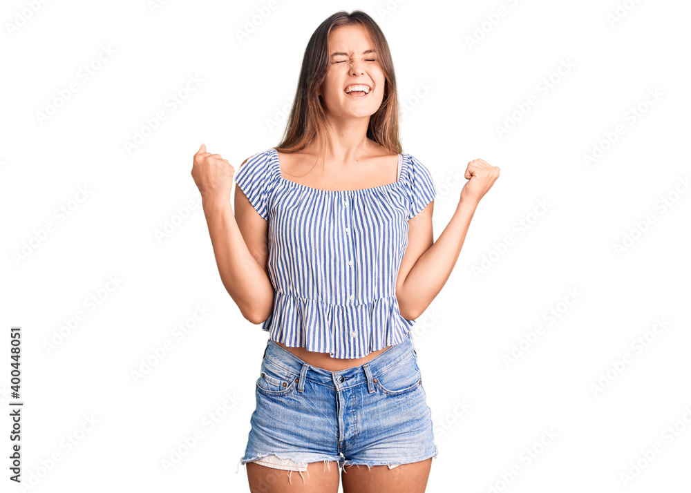 Beautiful caucasian woman wearing casual clothes very happy and excited doing winner gesture with arms raised, smiling and screaming for success. celebration concept. Beautiful caucasian woman wearing casual clothes very happy and excited doing winner gesture with arms raised, smiling and screaming for success. celebration concept.