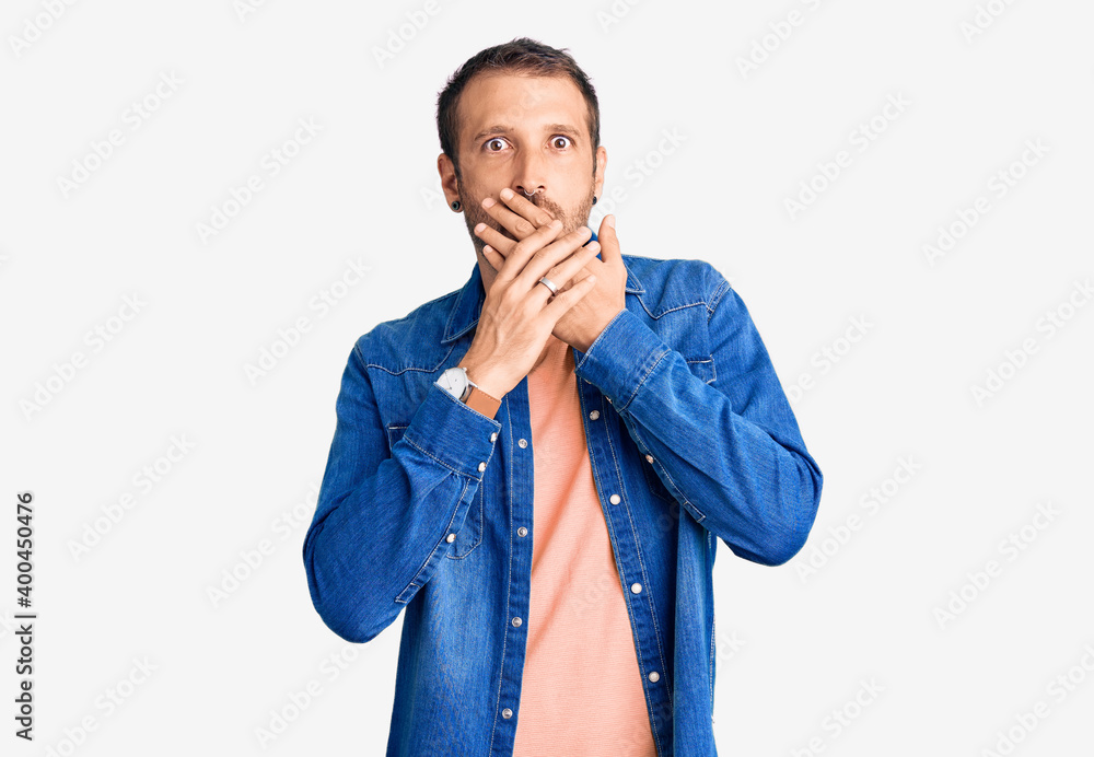 Young handsome man wearing casual clothes shocked covering mouth with hands for mistake. secret concept. Young handsome man wearing casual clothes shocked covering mouth with hands for mistake. secret concept.