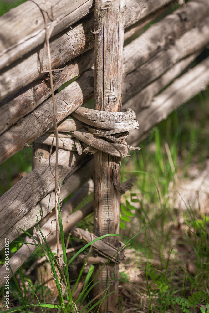 Handmade fence of spruce with a bundle of spruce branches from the Swedish forest which is an old craft that is most visible in the Swedish countryside Handmade fence of spruce with a bundle of spruce branches from the Swedish forest which is an old craft that is most visible in the Swedish countryside