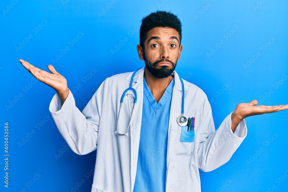 Handsome hispanic man with beard wearing doctor uniform and stethoscope clueless and confused with open arms, no idea and doubtful face. Handsome hispanic man with beard wearing doctor uniform and stethoscope clueless and confused with open arms, no idea and doubtful face.