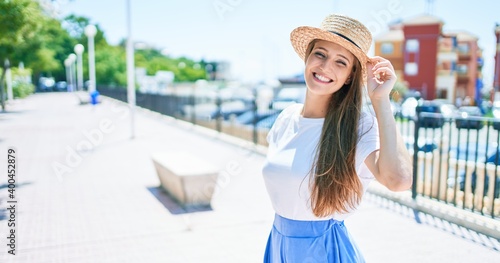 Young blonde woman on vacation smiling happy walking at street of city © Krakenimages.com