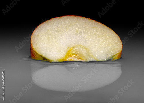 Still life with a slice of red apple on the table