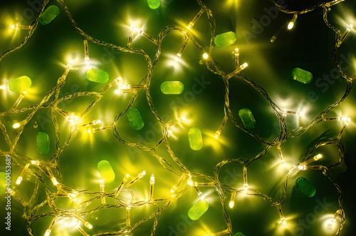 Green lollipops on a background of garlands on the table