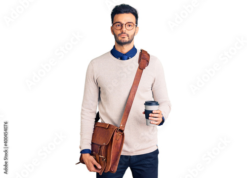 Obraz na plátně Young handsome hispanic man wearing leather bag and drinking take away coffee th