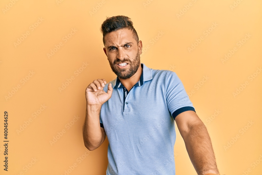Handsome man with beard wearing casual clothes disgusted expression, displeased and fearful doing disgust face because aversion reaction. with hands raised Handsome man with beard wearing casual clothes disgusted expression, displeased and fearful doing disgust face because aversion reaction. with hands raised