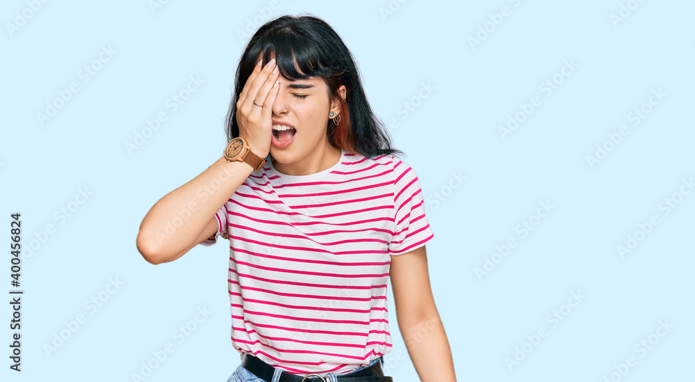 Young hispanic girl wearing casual clothes yawning tired covering half face, eye and mouth with hand. face hurts in pain. Young hispanic girl wearing casual clothes yawning tired covering half face, eye and mouth with hand. face hurts in pain.