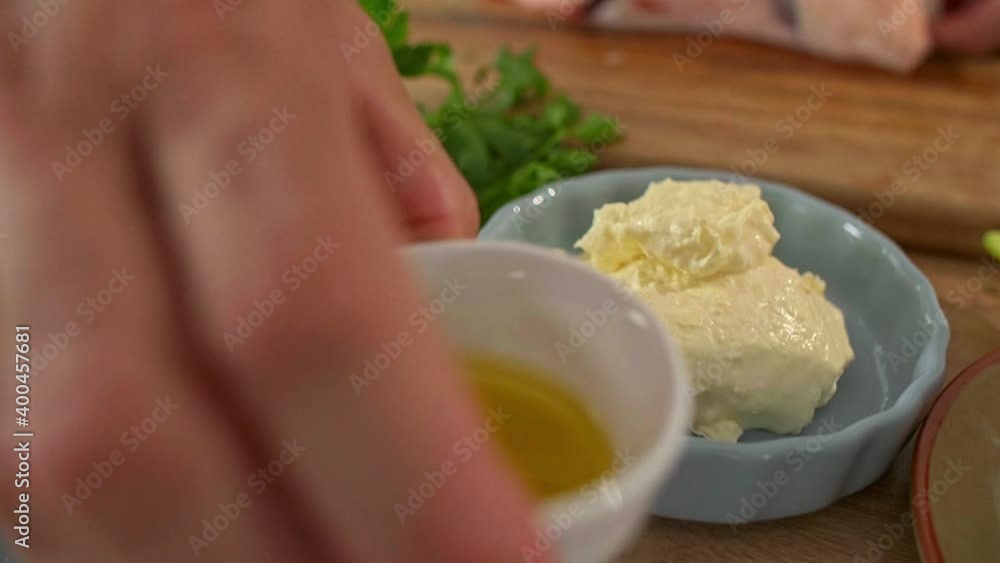 Close-up of a chef rubbing olive oil on meat Close-up of a chef rubbing olive oil on meat