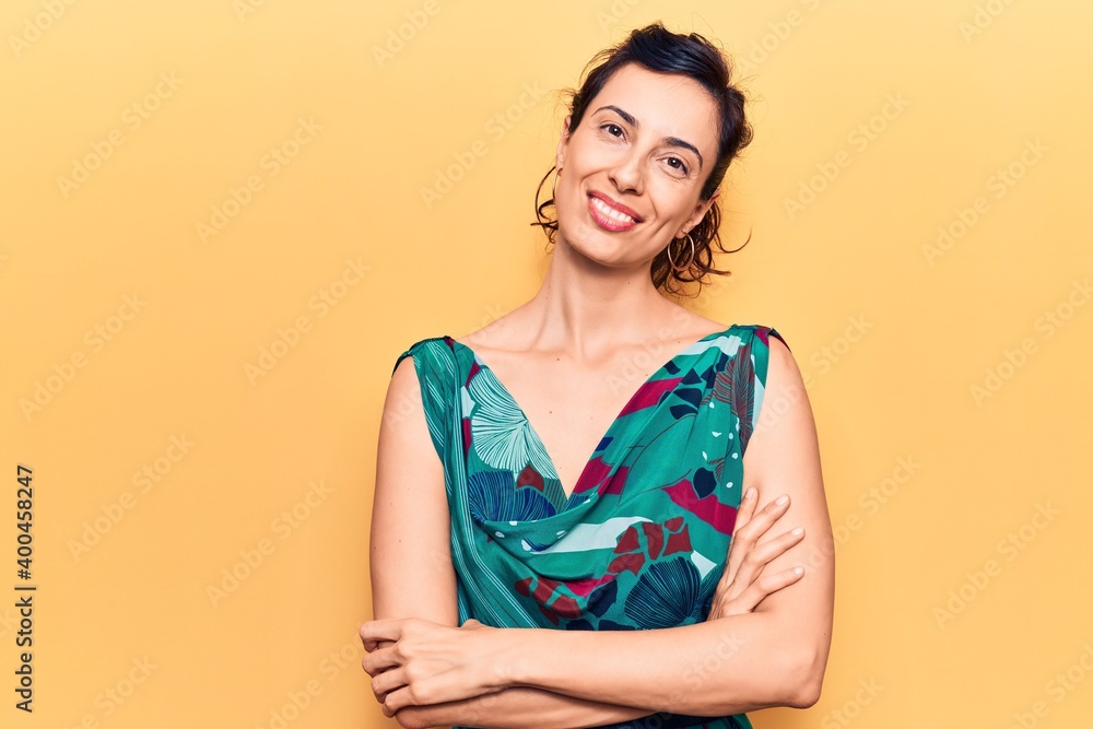 Obraz premium Young beautiful hispanic woman wearing casual clothes happy face smiling with crossed arms looking at the camera. positive person.