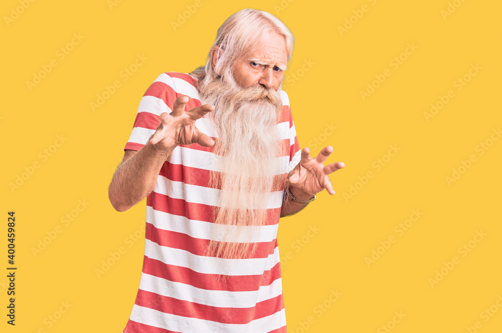 Old senior man with grey hair and long beard wearing striped tshirt disgusted expression, displeased and fearful doing disgust face because aversion reaction. Old senior man with grey hair and long beard wearing striped tshirt disgusted expression, displeased and fearful doing disgust face because aversion reaction.