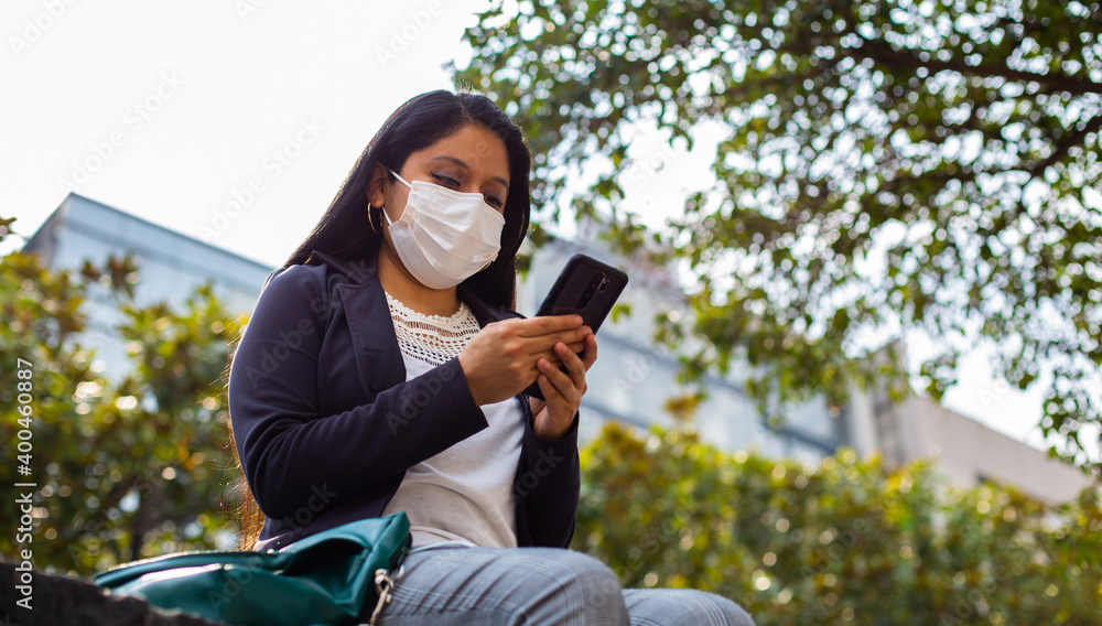 Latin businesswoman wearing a face mask for protective reasons during the covid 19 pandemic. Latin businesswoman wearing a face mask for protective reasons during the covid 19 pandemic.