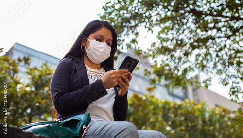 Latin businesswoman wearing a face mask for protective reasons during the covid 19 pandemic.
