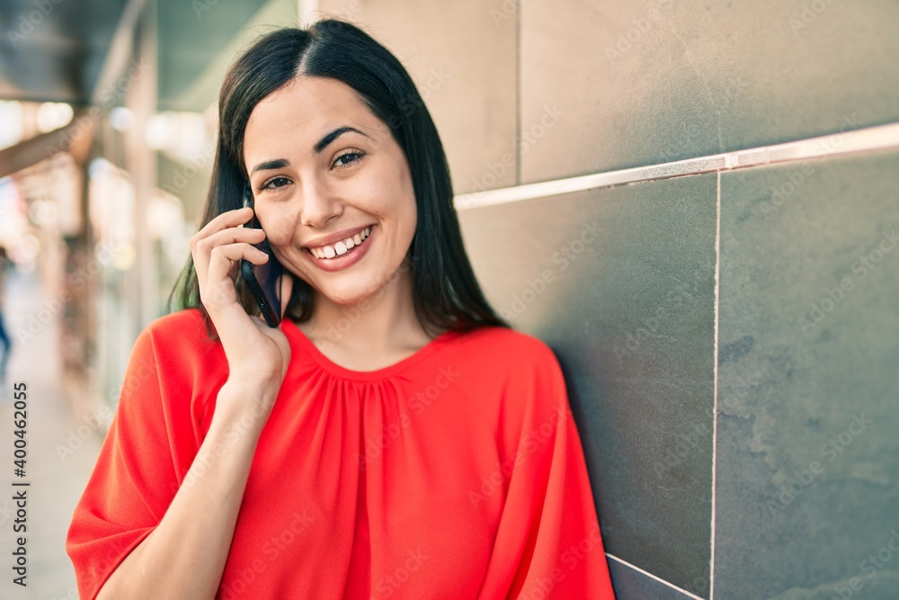 Young latin girl smiling happy talking on the smartphone at the city. Young latin girl smiling happy talking on the smartphone at the city.