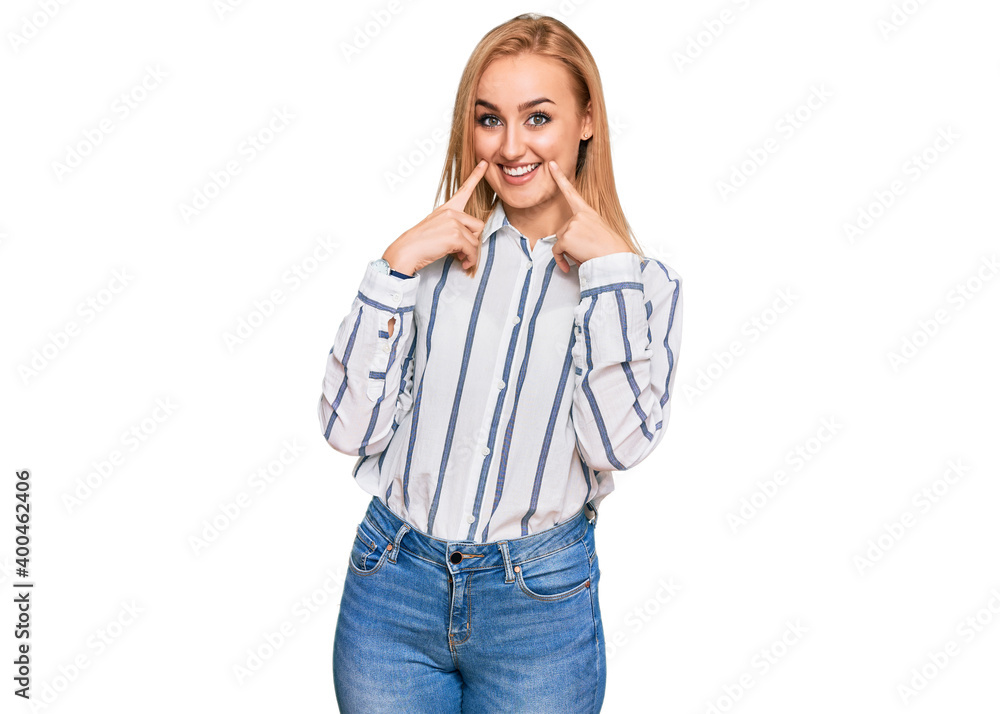Beautiful caucasian woman wearing casual clothes smiling with open mouth, fingers pointing and forcing cheerful smile Beautiful caucasian woman wearing casual clothes smiling with open mouth, fingers pointing and forcing cheerful smile