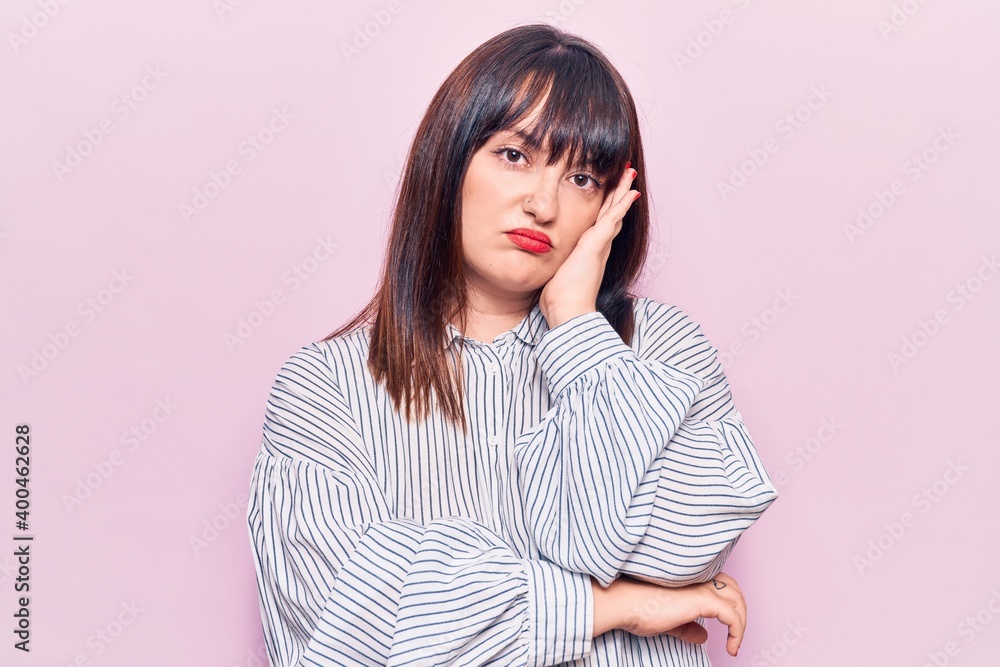 Young plus size woman wearing casual clothes thinking looking tired and bored with depression problems with crossed arms. Young plus size woman wearing casual clothes thinking looking tired and bored with depression problems with crossed arms.
