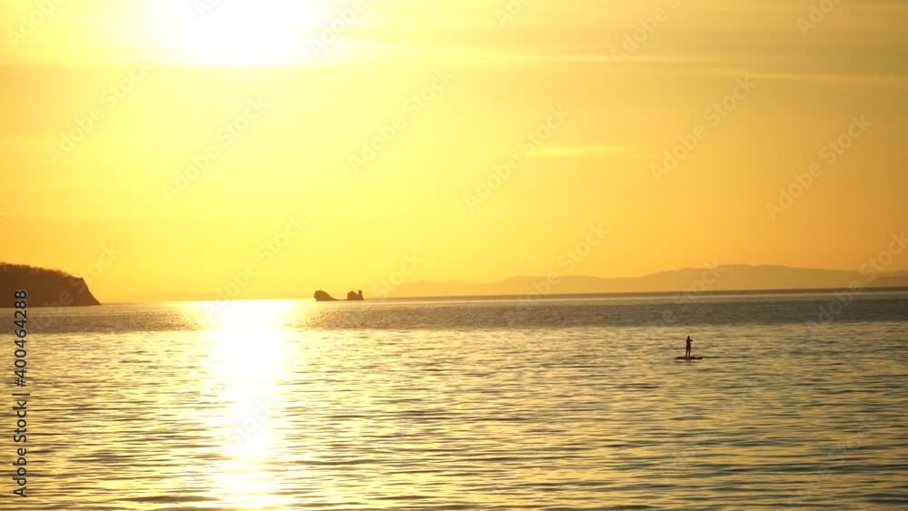 Sea landscape with silhouettes of the Islands and the people on the SAP boards. Sea landscape with silhouettes of the Islands and the people on the SAP boards.