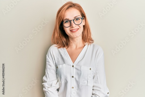 Young caucasian woman wearing casual clothes and glasses with a happy and cool smile on face. lucky person.
