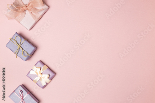 Pastel pink and purple gift boxes on pink background. flat lay, top view, copy space © Sanga