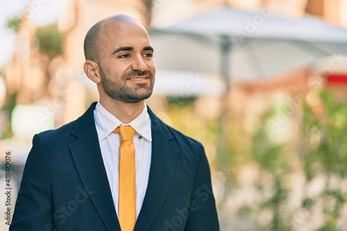 Wallpaper Mural Young hispanic bald businessman smiling happy standing at the city. Torontodigital.ca