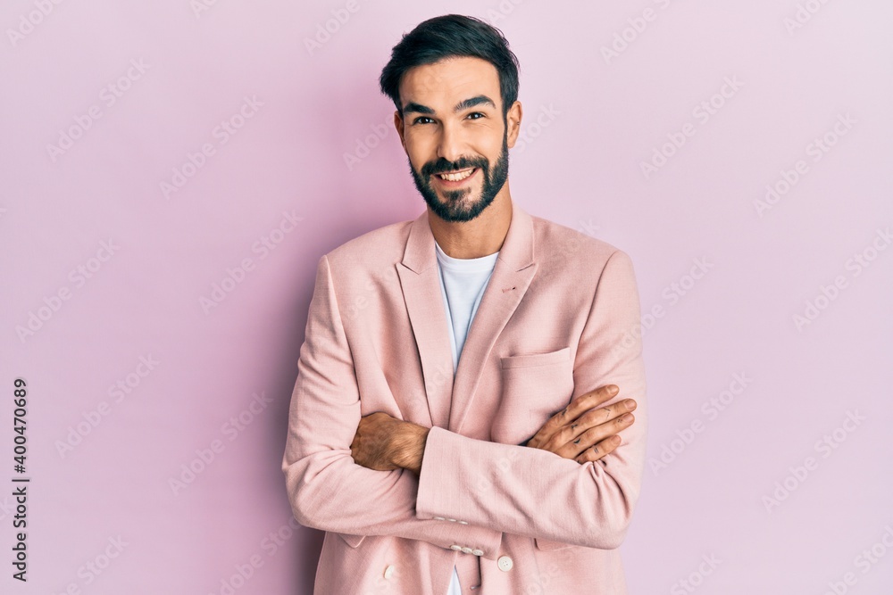 Young hispanic man wearing business jacket happy face smiling with crossed arms looking at the camera. positive person. Young hispanic man wearing business jacket happy face smiling with crossed arms looking at the camera. positive person.