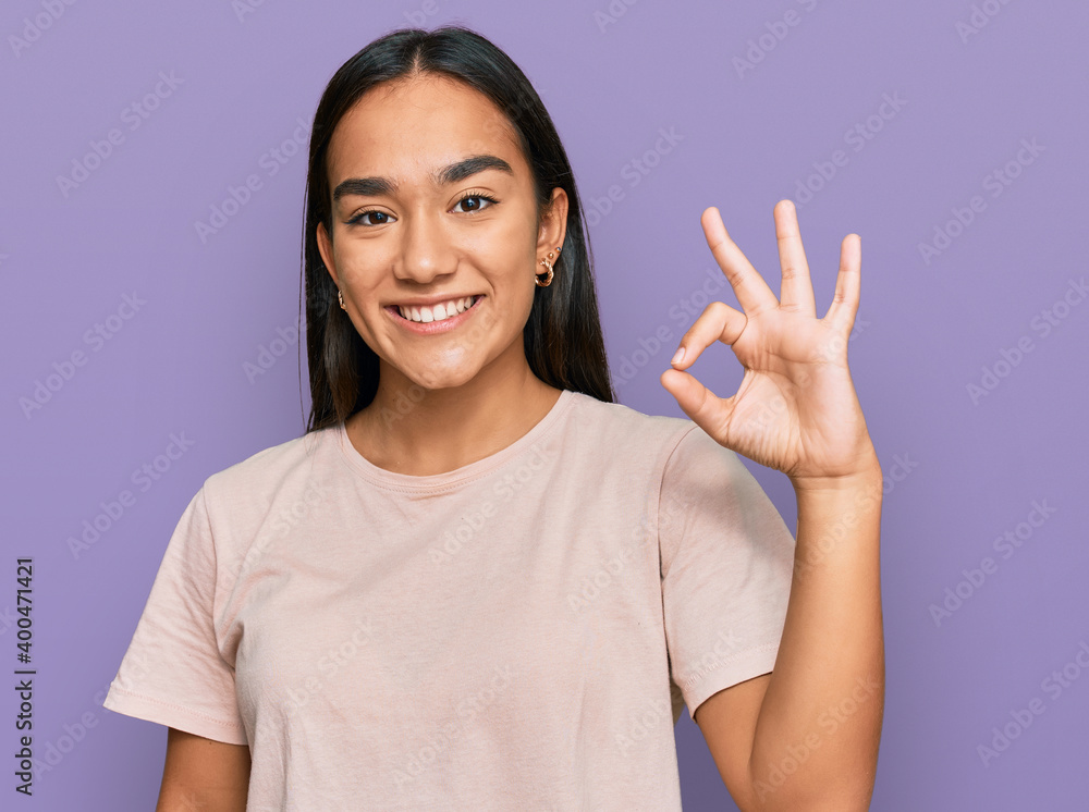 Young asian woman wearing casual clothes smiling positive doing ok sign with hand and fingers. successful expression. Young asian woman wearing casual clothes smiling positive doing ok sign with hand and fingers. successful expression.