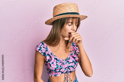 Teenager caucasian girl wearing summer hat feeling unwell and coughing as symptom for cold or bronchitis. health care concept.