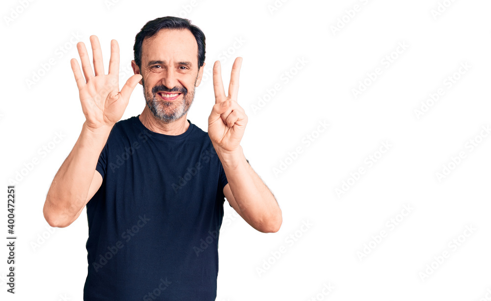 Middle age handsome man wearing casual t-shirt showing and pointing up with fingers number seven while smiling confident and happy. Middle age handsome man wearing casual t-shirt showing and pointing up with fingers number seven while smiling confident and happy.