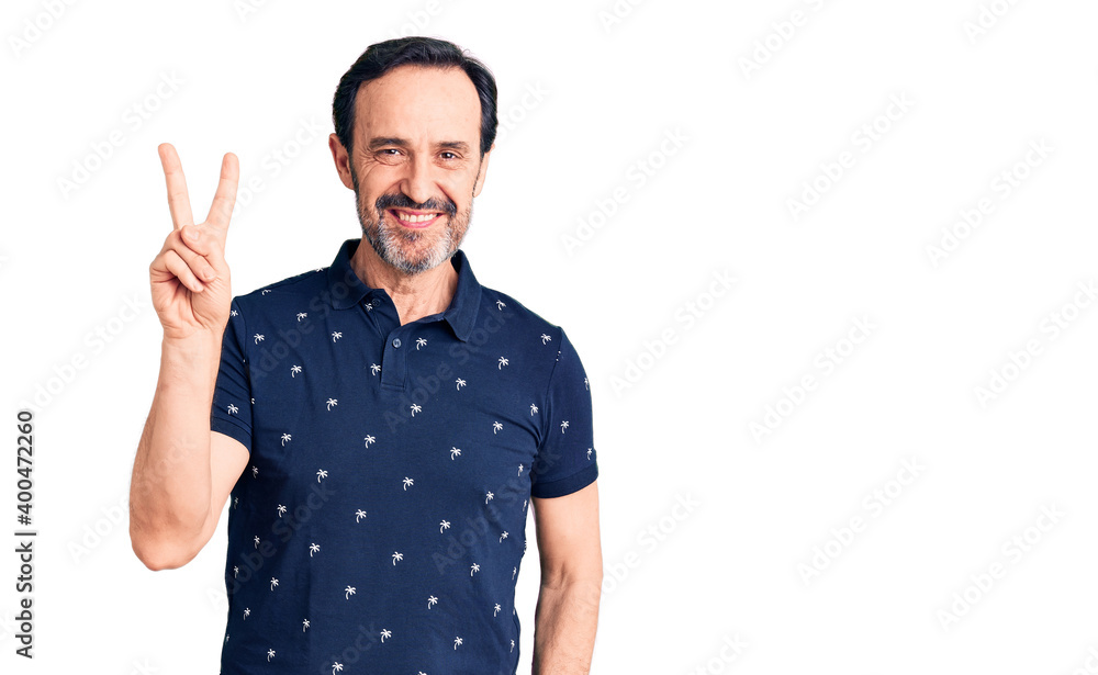 Middle age handsome man wearing casual polo smiling with happy face winking at the camera doing victory sign. number two. Middle age handsome man wearing casual polo smiling with happy face winking at the camera doing victory sign. number two.
