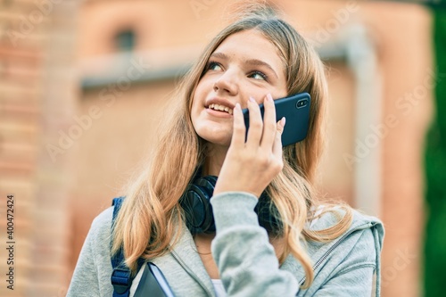 Beautiful caucasian student teenager smiling happy talking on the smartphone at the university.