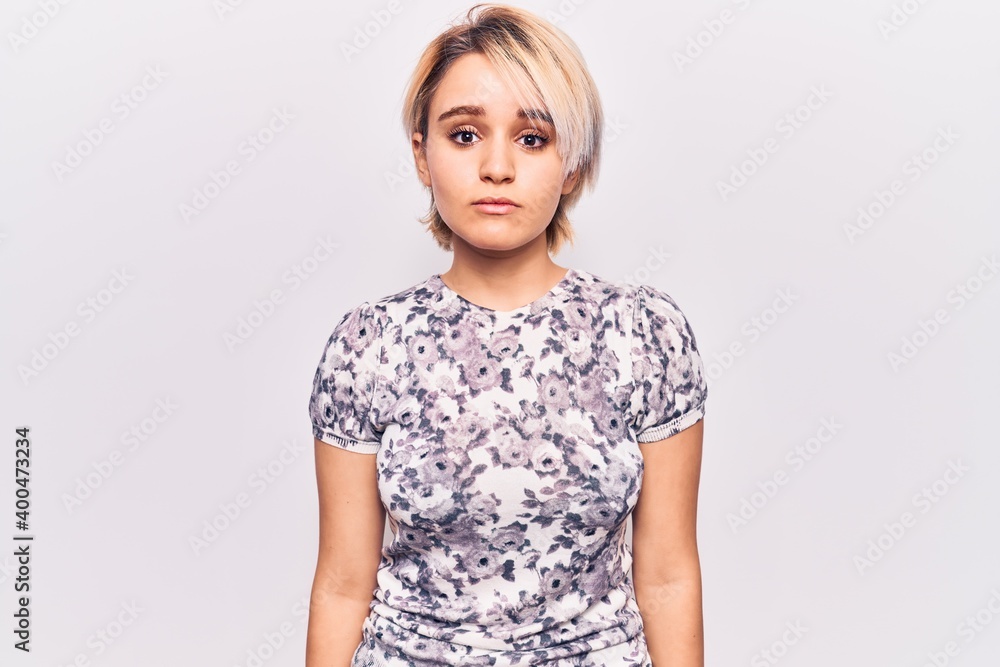 Young beautiful blonde woman wearing casual clothes with serious expression on face. simple and natural looking at the camera. Young beautiful blonde woman wearing casual clothes with serious expression on face. simple and natural looking at the camera.