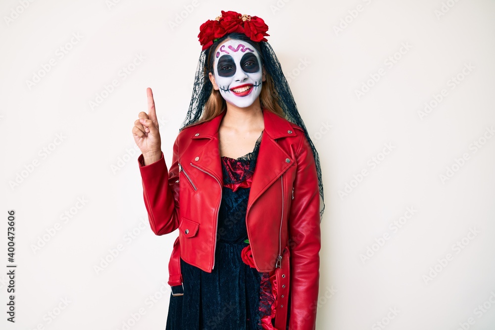 Woman wearing day of the dead costume over white pointing finger up with successful idea. exited and happy. number one.