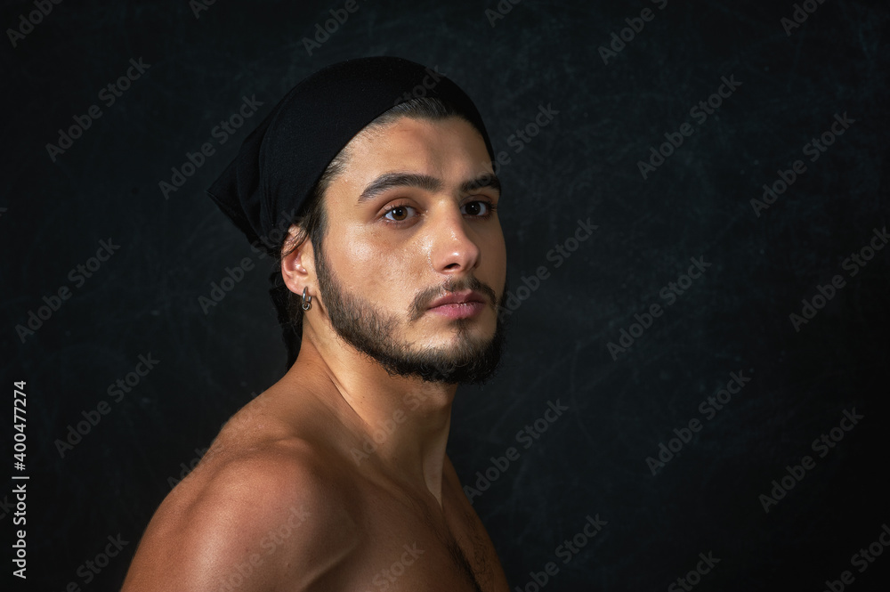 Fototapeta premium Portrait of a young man with a naked torso in the studio