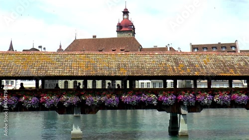 Iconic Chapel Bridge over the Reuss River in Luzern, Lucerne, Switzerland. Town Hall tower in background.
