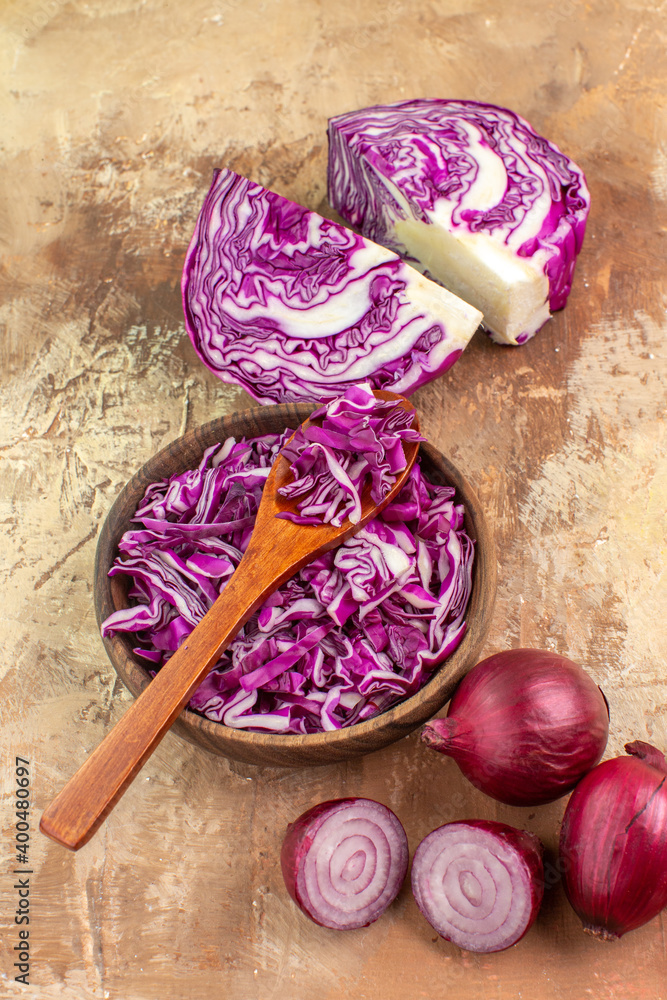 top view preparation for a healthy salad with a red cabbage and onions on a wooden background with copy space
