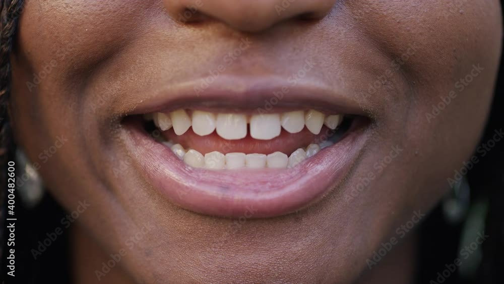 Close up shot of young black womans mouth talking direct to camera Close up shot of young black womans mouth talking direct to camera