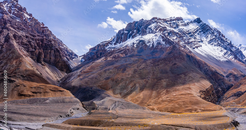Panoramic landscape of braided Spiti river valley and snow capped mountains during sunrise from Losar village near Kaza town in Lahaul and Spiti district of Himachal Pradesh, India.