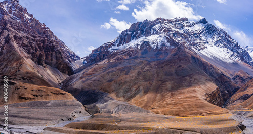 Panoramic landscape of braided Spiti river valley and snow capped mountains during sunrise from Losar village near Kaza town in Lahaul and Spiti district of Himachal Pradesh, India.