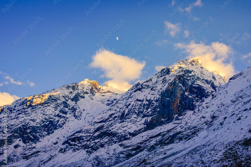 Serene Landscape of snow capped Pir Panjal mountains range during sunset twilight near Rohtang Pass enroute to Manali from Kaza town in Lahaul & Spiti district of Himachal Pradesh, India.