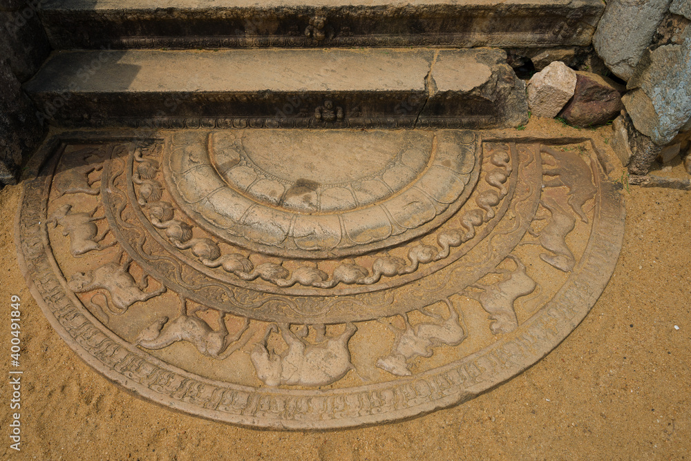 Ancient moonstone at the entrance to a Buddhist temple. Anuradhapura, Sri Lanka