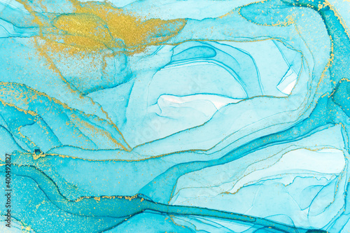Abstract layers of blue paint background. Blue and gold watercolor pattern.
