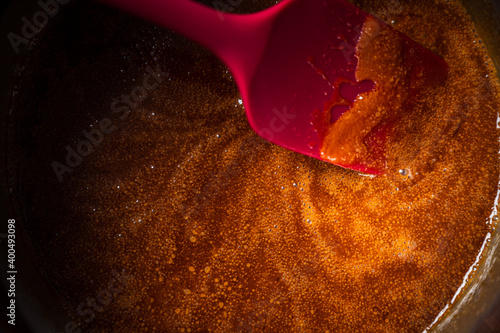 Caramel cooking in a saucepan with a spatula
