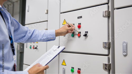 Electrical engineer checking electrical voltage at circuit breaker air ...
