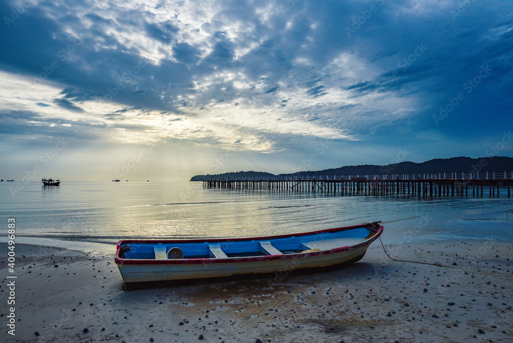 beautiful landscape of the blue sky, wooden boat, wooden bridgeon the Kohrong Samloem beach at Cambodia